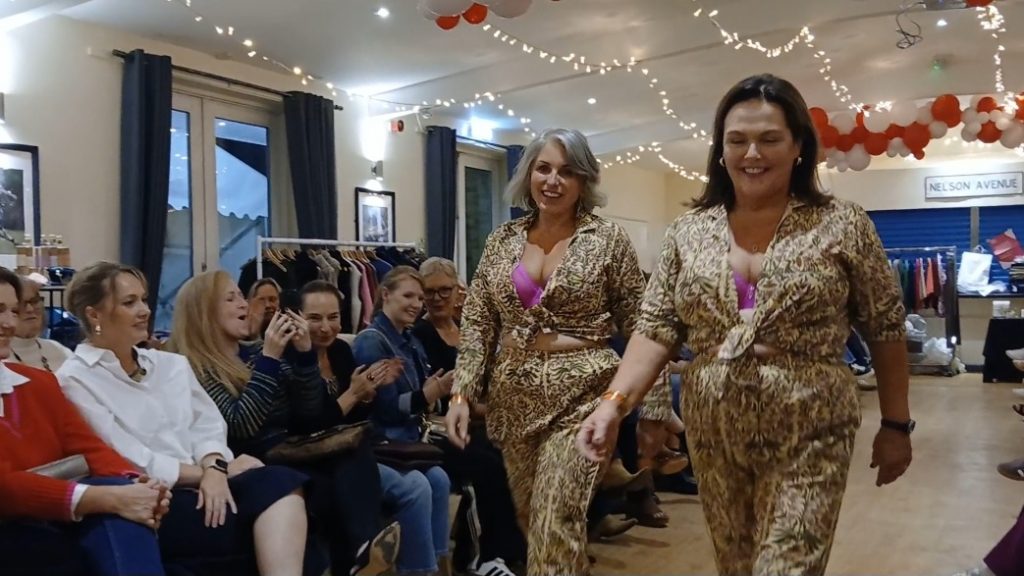Two models walking down the runway in seagrass bay outfits, including cheater print silk pajamas and pink lingerie