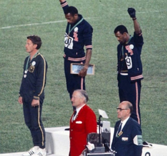 This image shows both John Carlos and Tommie Smith lifting their fists in support of black lives courtesy of Angelo Cozzi (Mondadori Publishers)