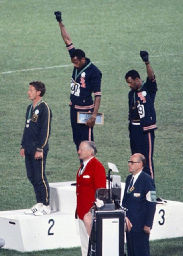 This image shows both John Carlos and Tommie Smith lifting their fists in support of black lives courtesy of Angelo Cozzi (Mondadori Publishers)